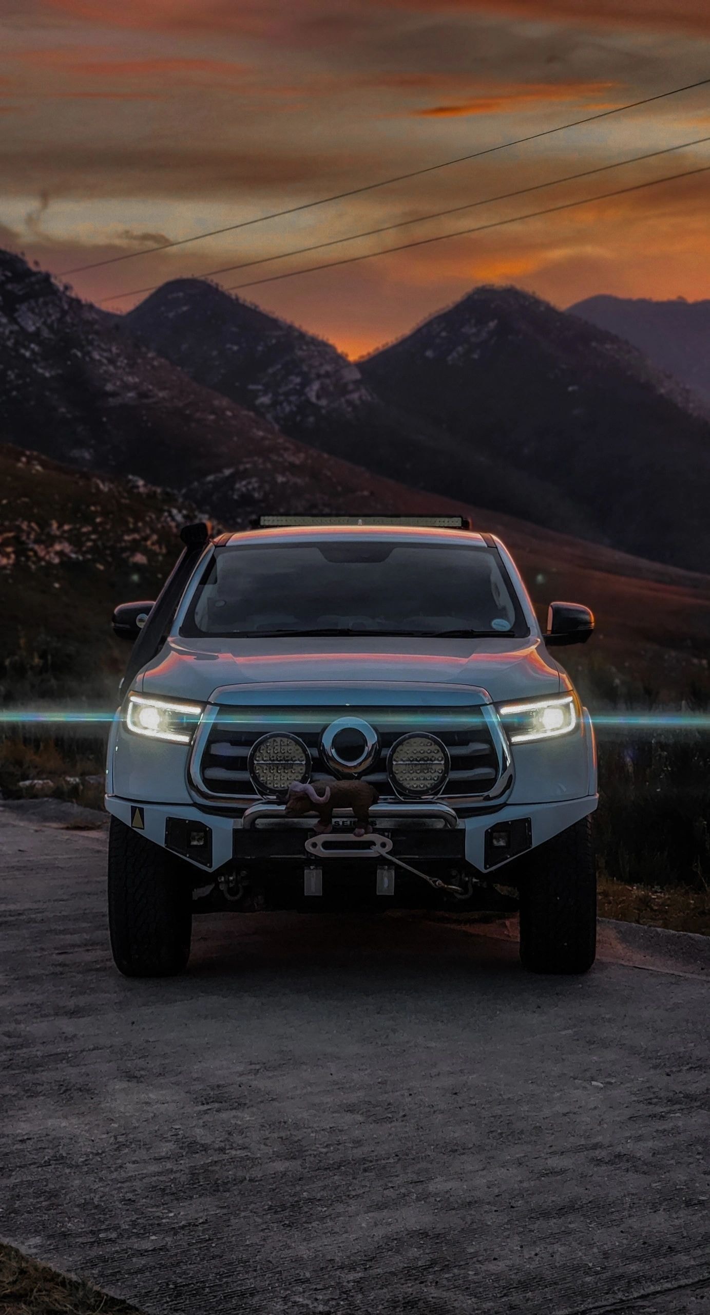Modified pickup truck — mountain sunset